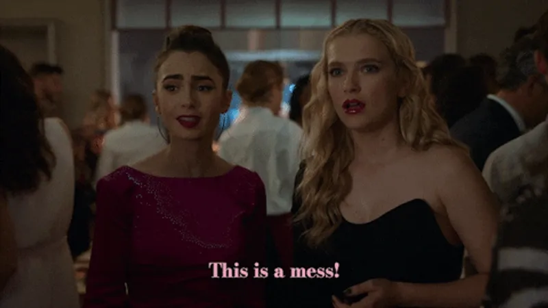 two ladies standing at a party staring at something in shock. one of them is saying 'this is a mess'.